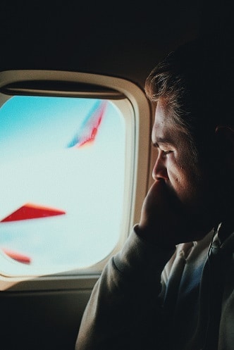 A man on a Qantas flight looking out the window