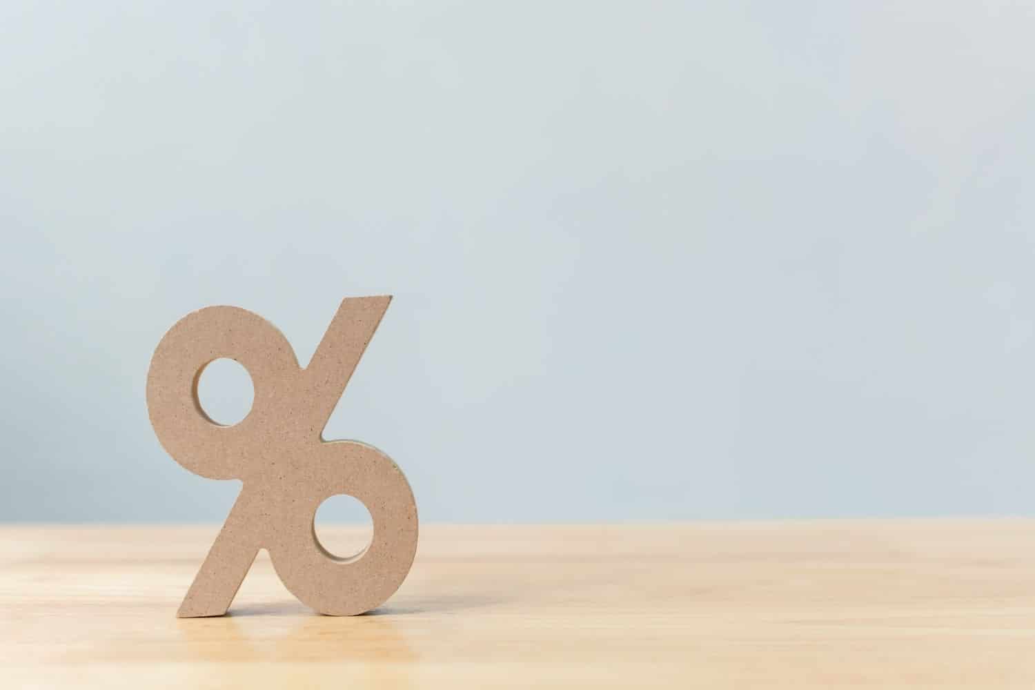 Wooden percentage sitting on top of desk.