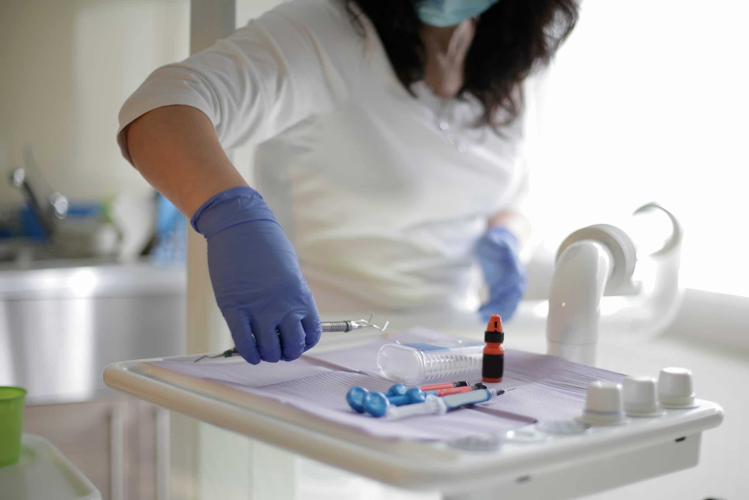 Cropped image of dentist organising dental tools.