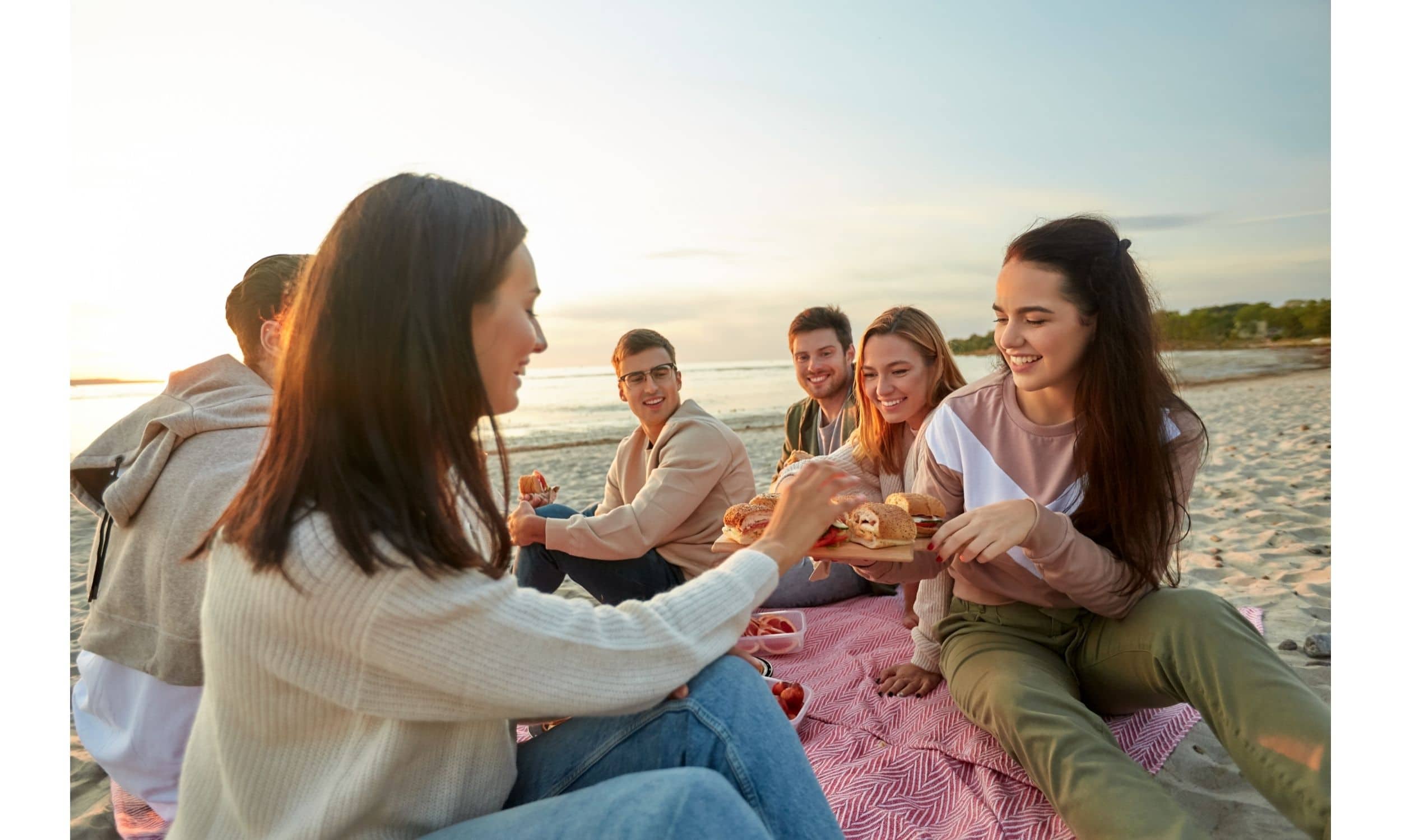 Friends having a picnic at the beach.
