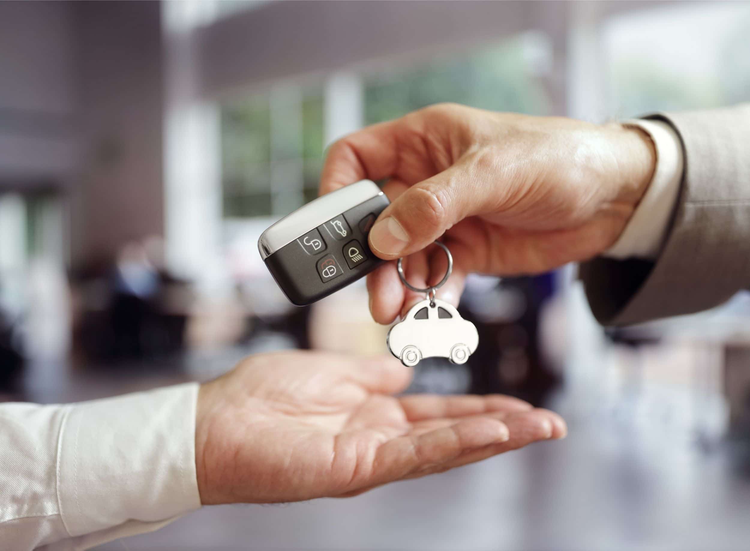 Car dealer handing over car keys