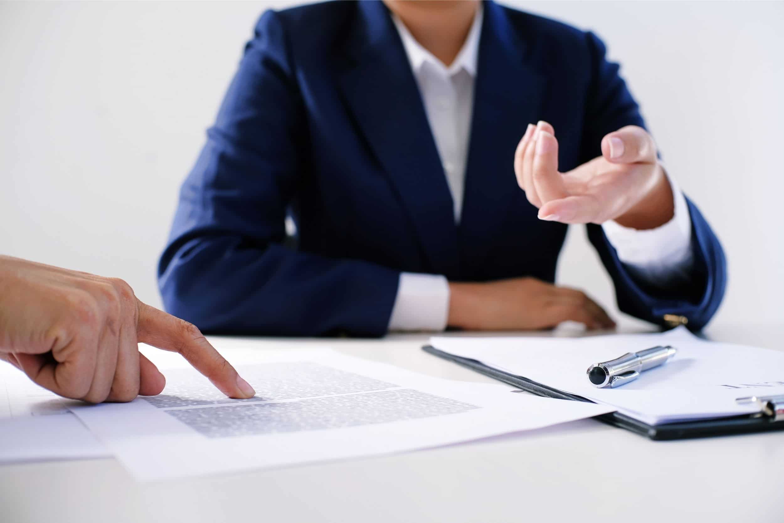 Sales manager giving advice and showing application form document