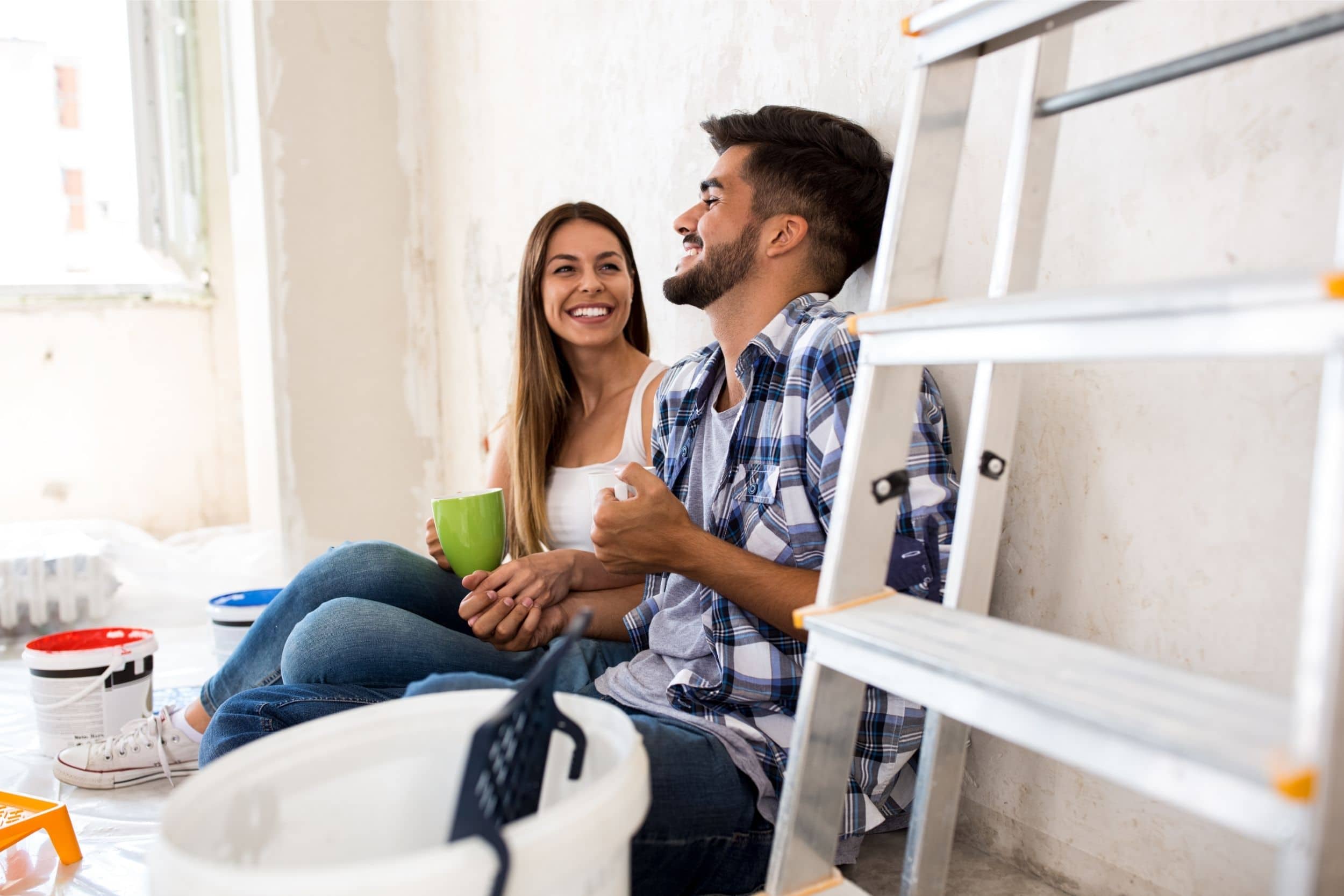 Happy young couple doing renovation for new home