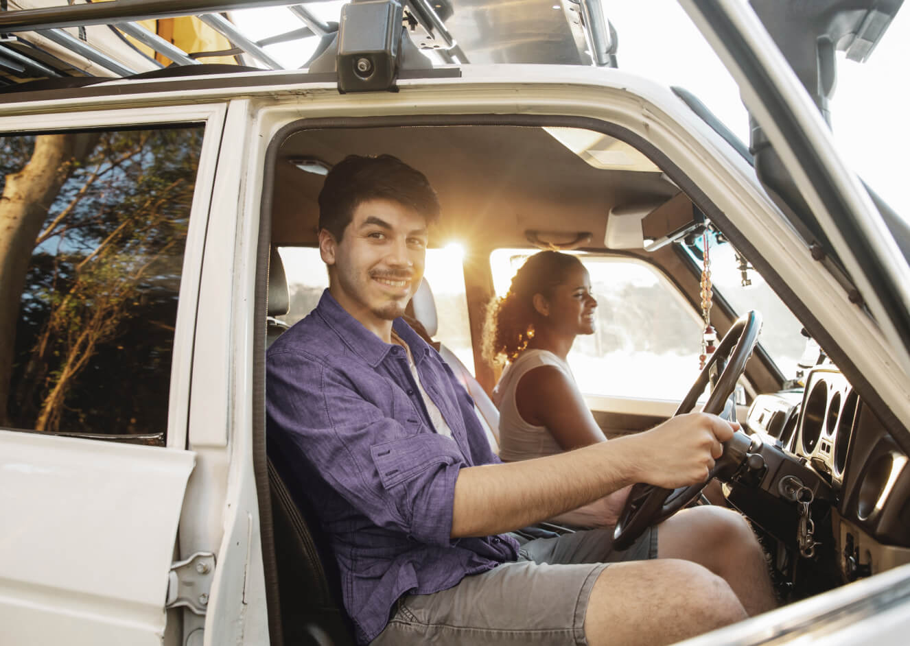 Photo of man and women sitting in car