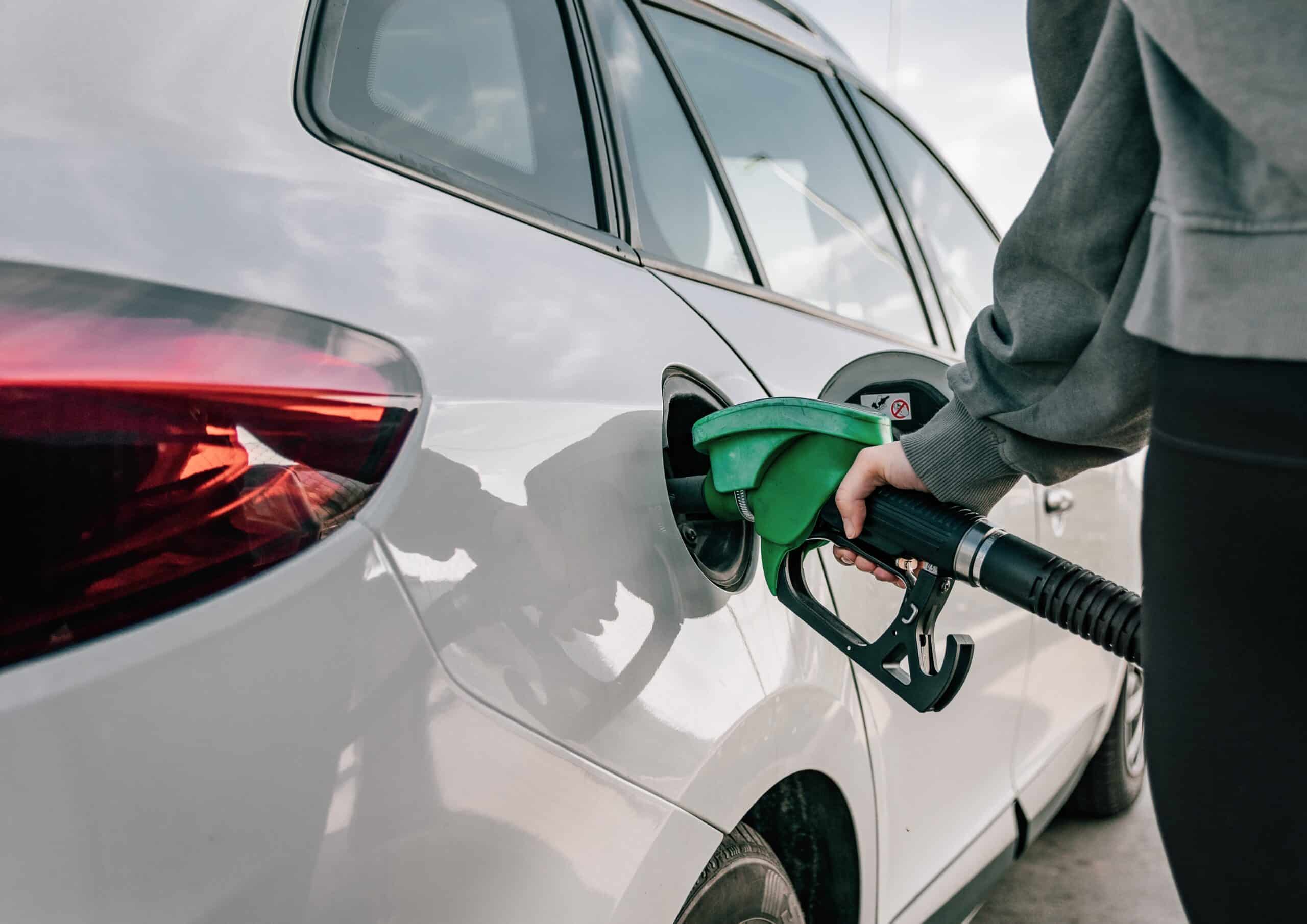 hand-refilling-car-with-fuel-at-gas-station-2022-03-12-13-26-08-utc