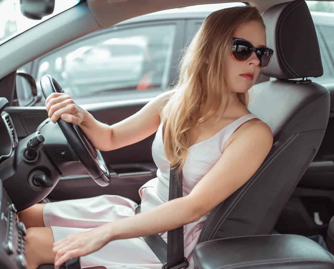 Woman in car looking behind her