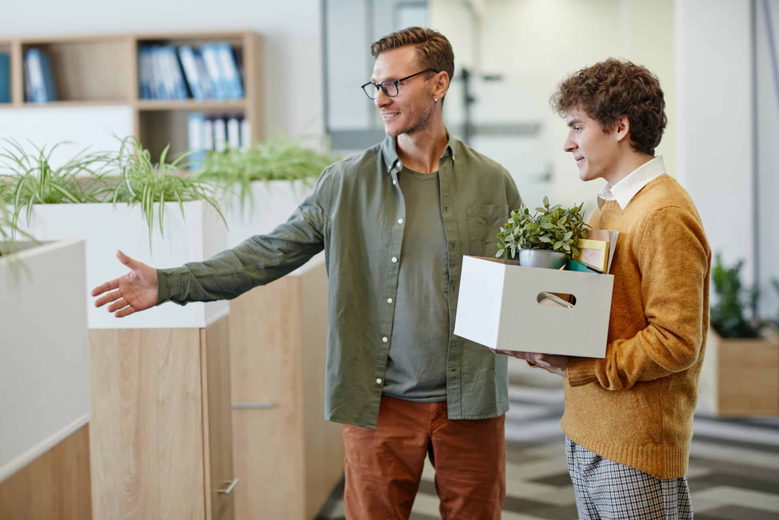Smiling Mentor Welcoming Young Man at New Job