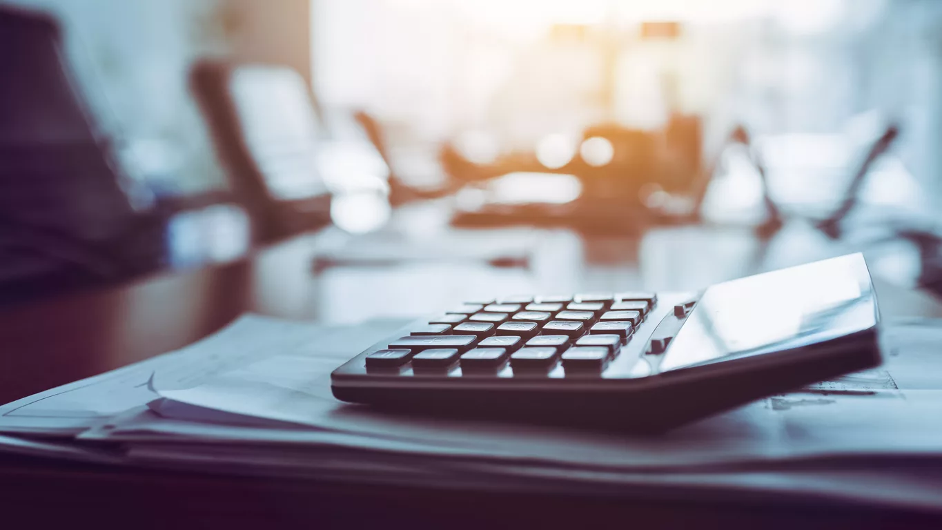 Close up calculator on business working desk, dark background concept.