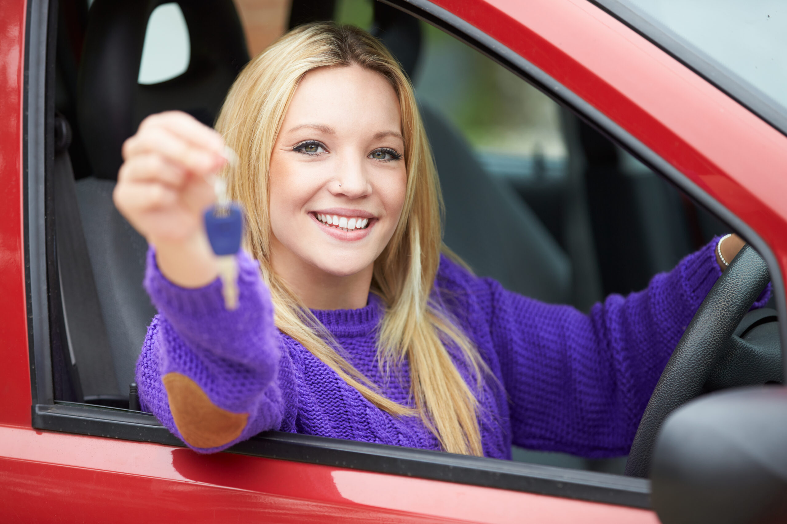 Teenage Sitting In Car Holding Key